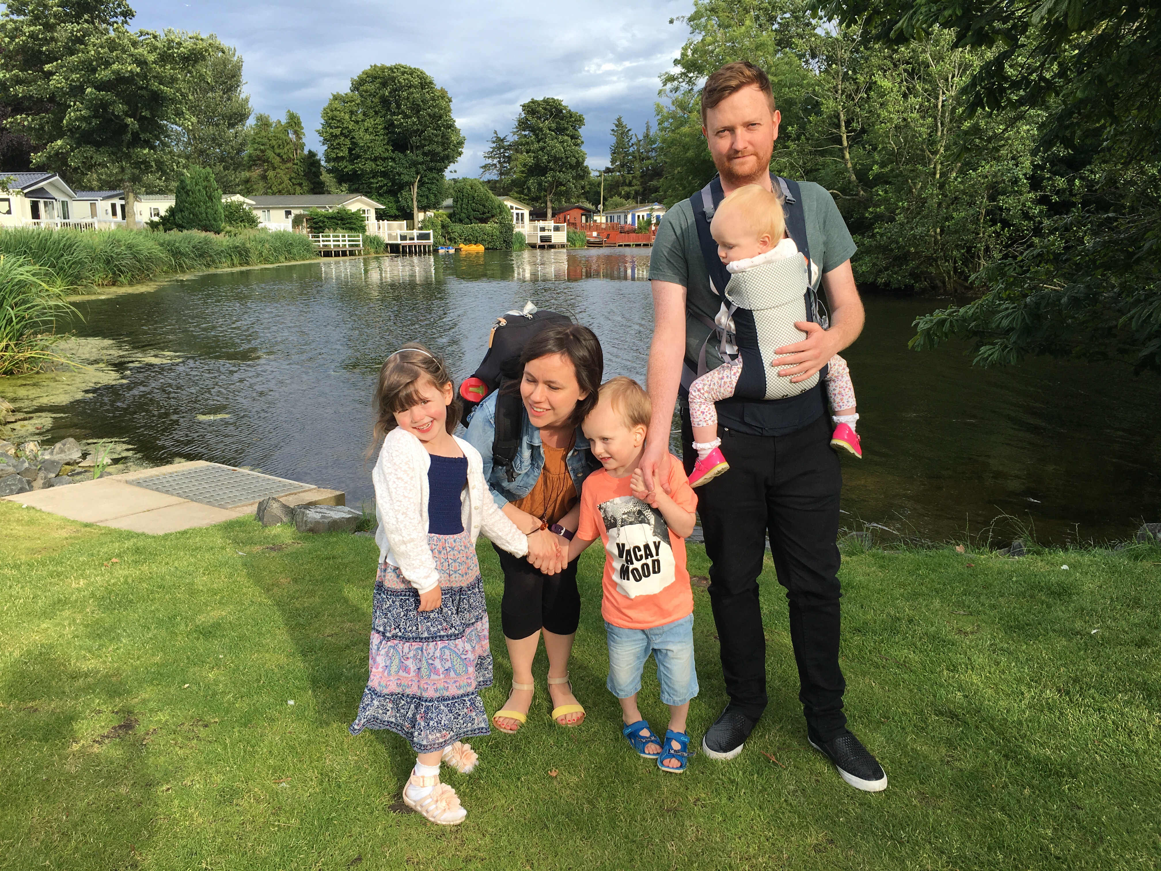 A family next to a boating lake at Haggerston Castle