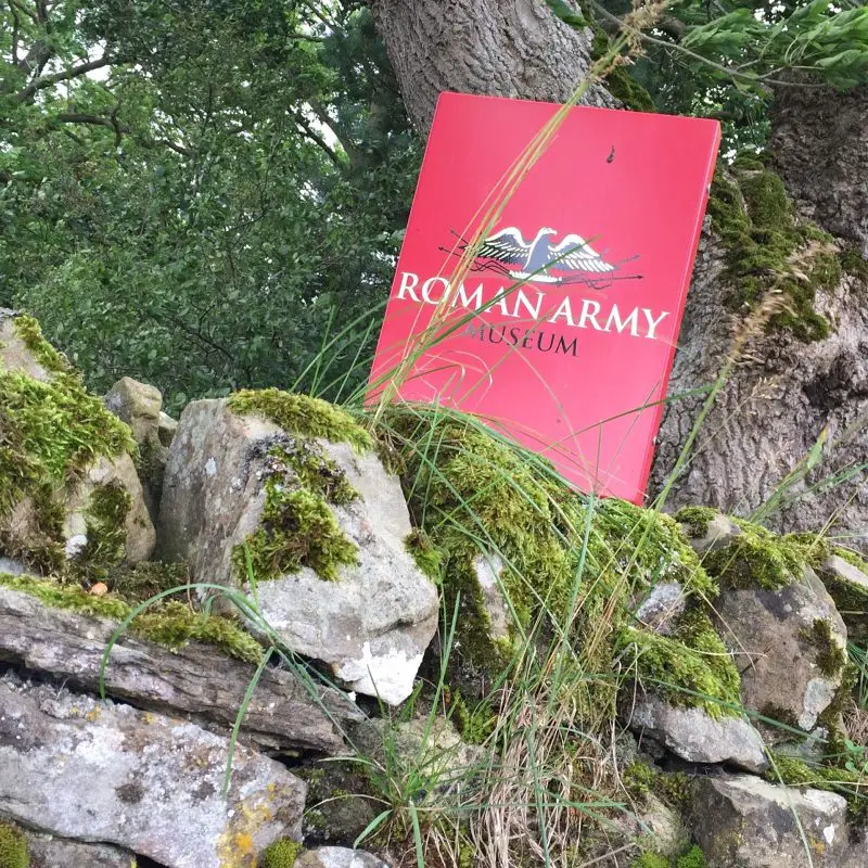 A roman army museum book on some mossy rocks at Hadrian's Wall