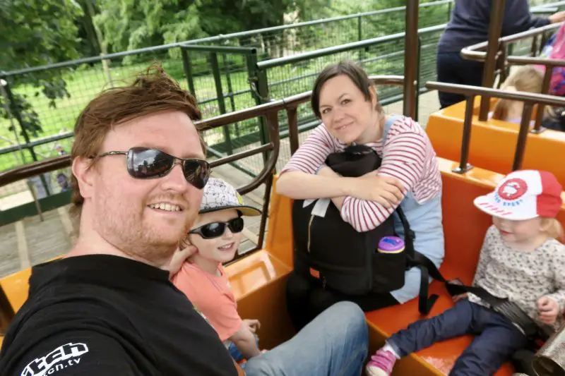 Flamingo Land Holiday Resort review - a family of 4 looking happy on a mono-rail ride at Flamingo land