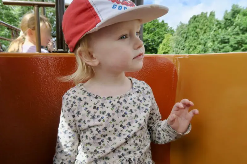 a 2 year old girl sat on the mono-rail ride at Flamingo Land