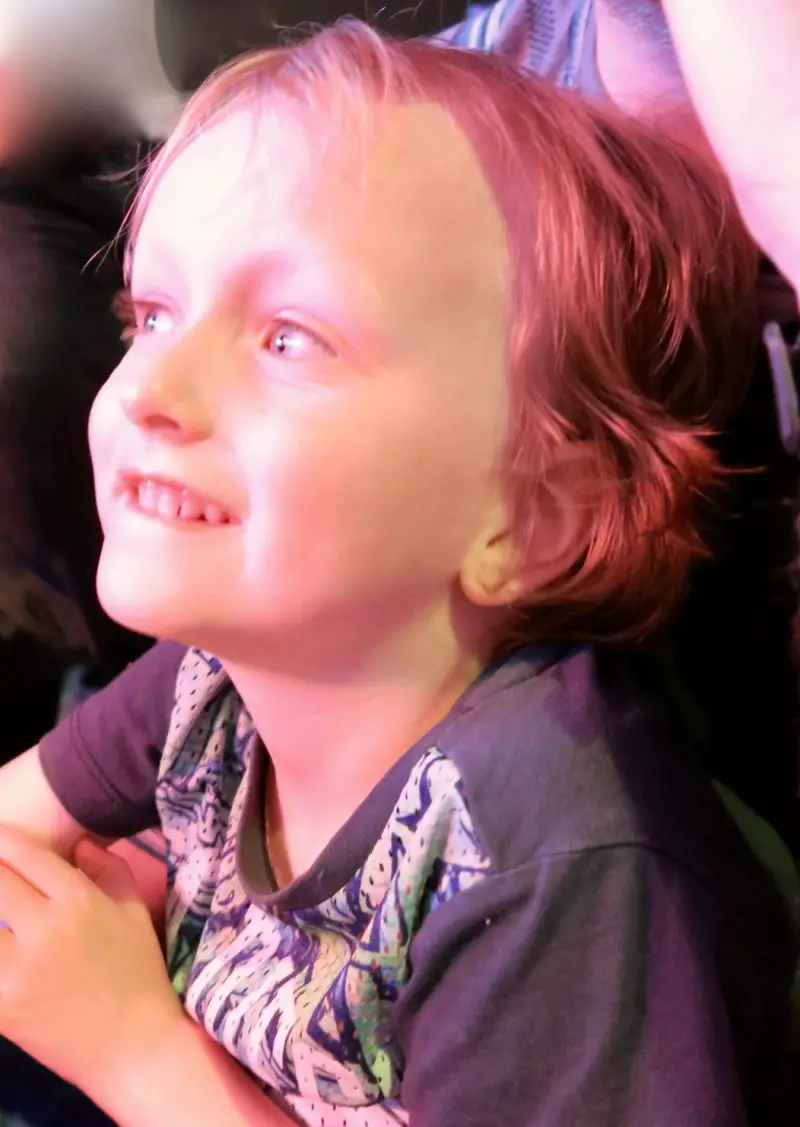 A 5 year old boy smiling whilst watching the kids entertainment at Flamingo Land Holiday Resort