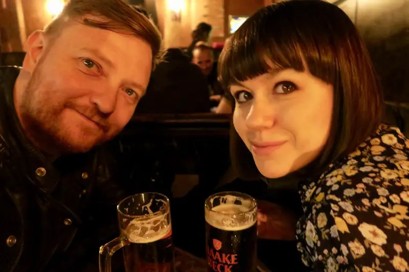 A couple drinking beer at a pub on a weekend in Berlin