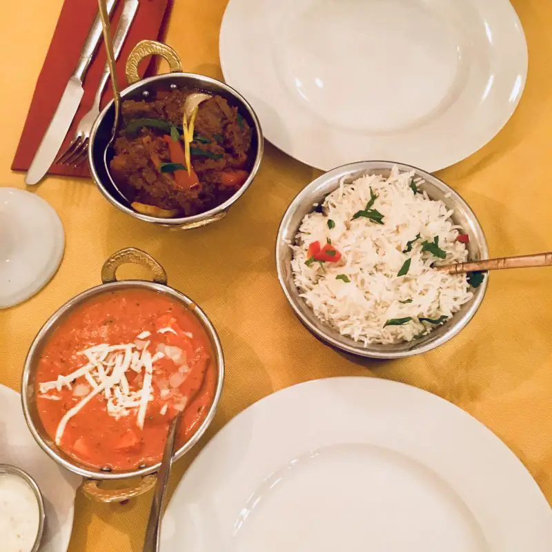 Indian food in small metal bowls 