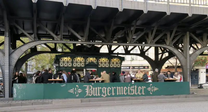 Burgermeister with people eating and drinking at tables 