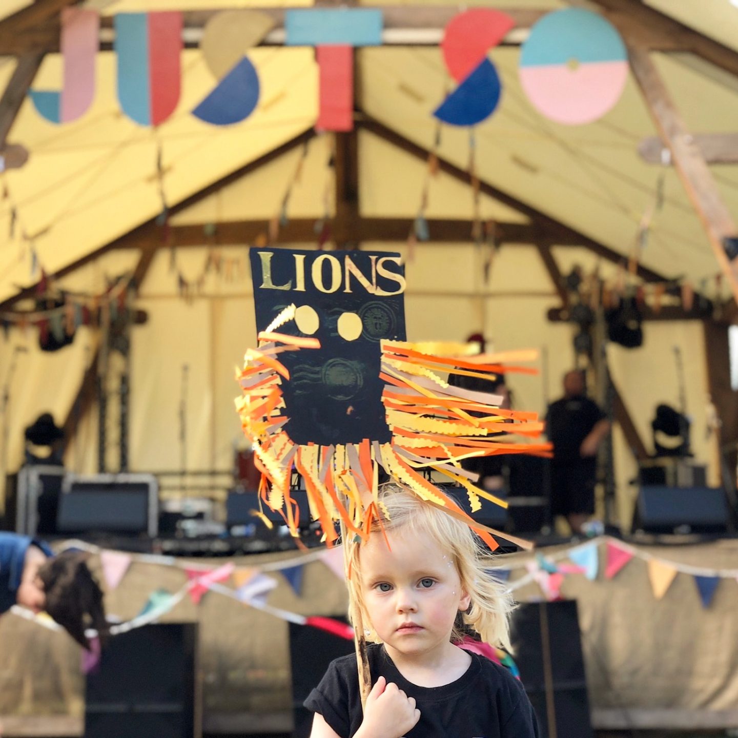 Little girl holding a lion sign at Just So Festival 