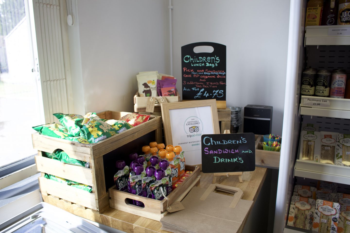 Children's food options in the cafe including jelly pouches, pom bear crisps, fruit roll ups - lunch bags priced £4.75