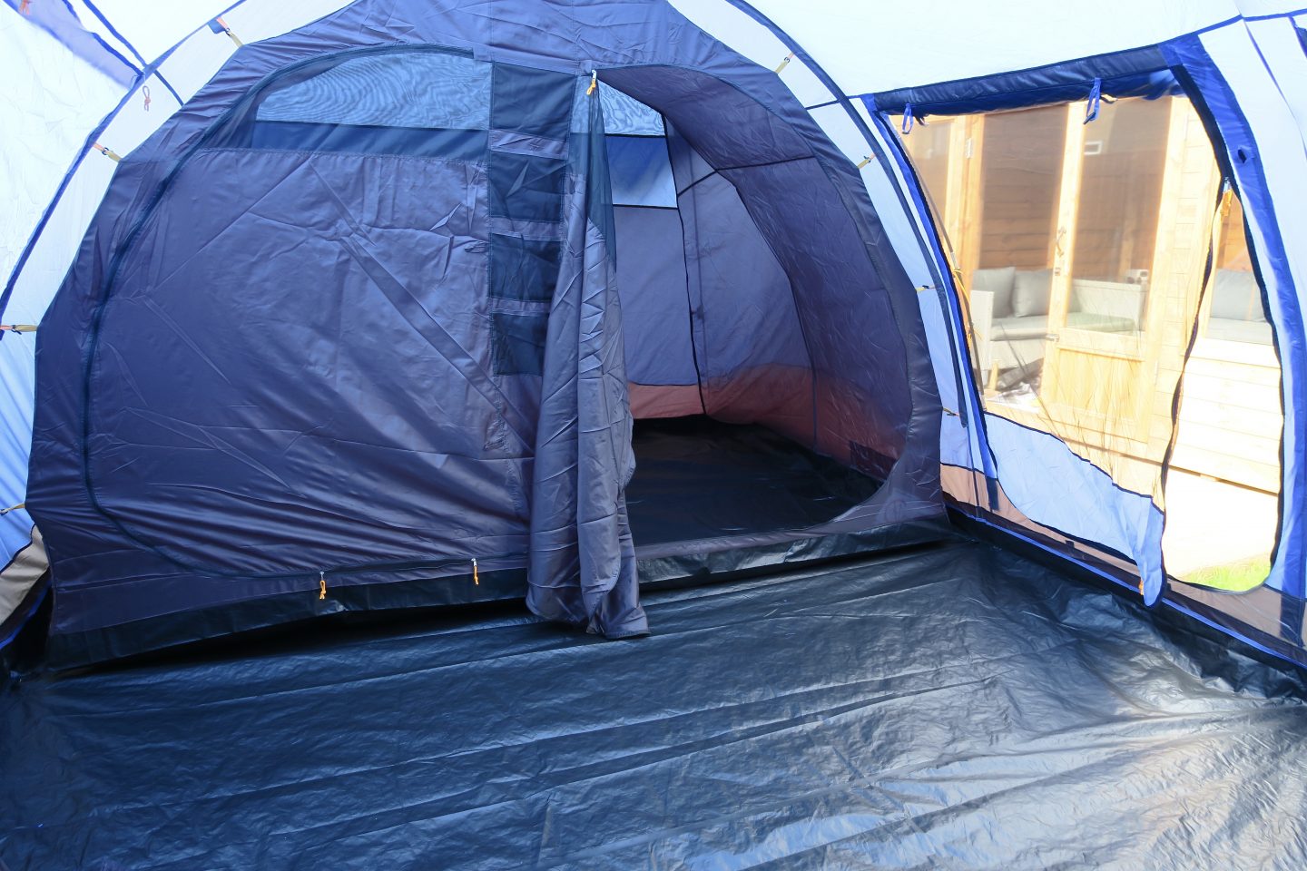 The inside of a blue tent showing a separate sleeping compartment