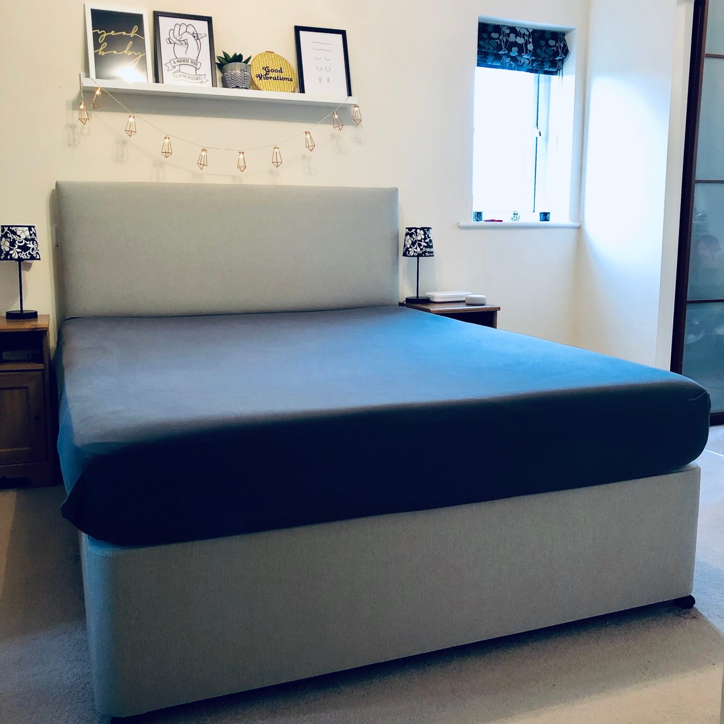 The Emma Mattress with a grey fitted sheet applied. The mattress looks wide and deep. 